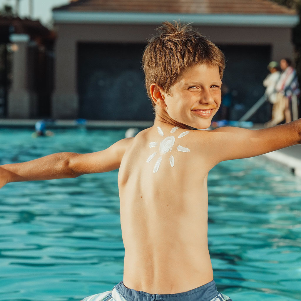 This image of a boy with his arms out by the pool is for decorative purposes.