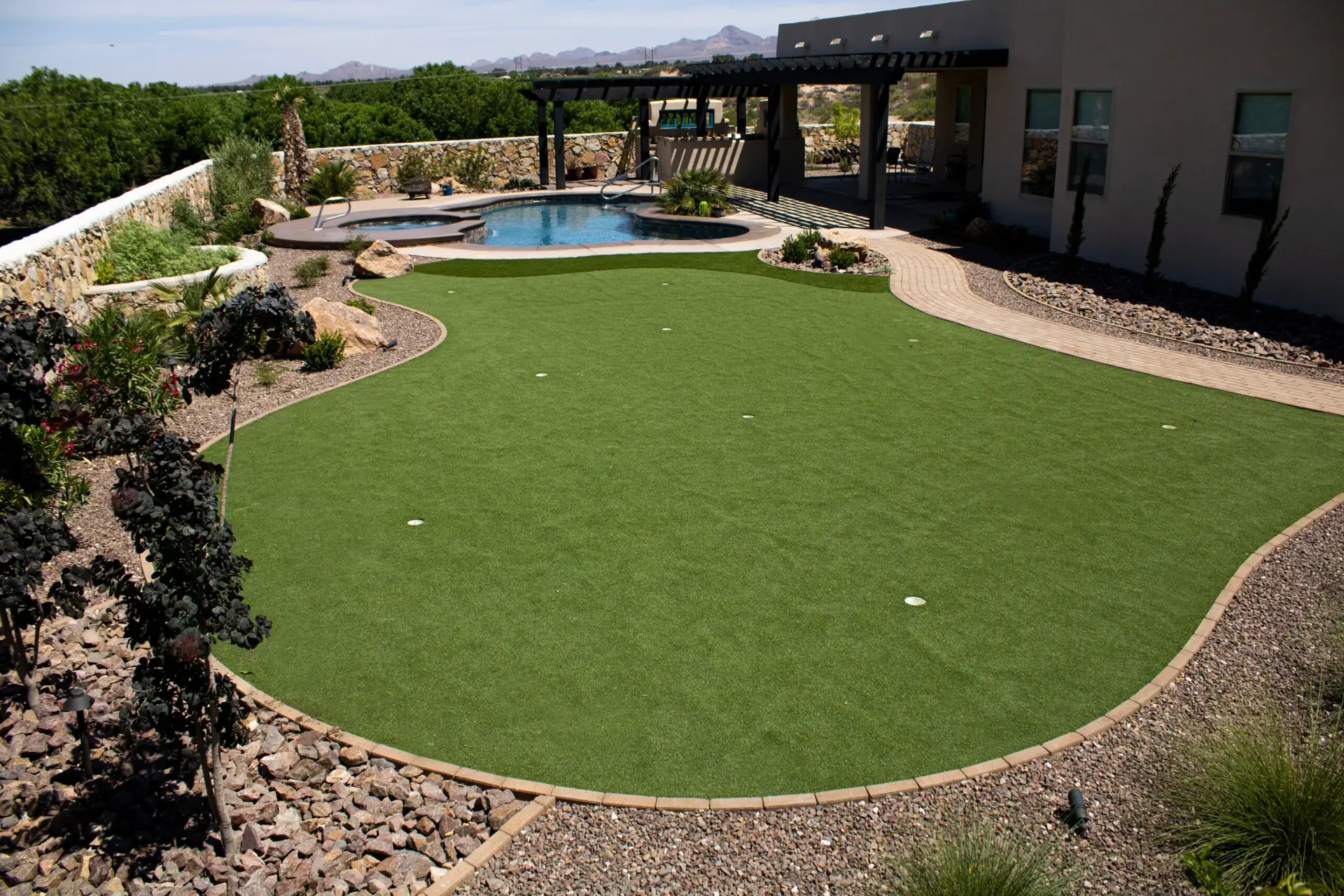 Separate landscaping is shown to demonstrate how additional landscaping can compliment a new fiberglass pool from Pools by Garden Center.